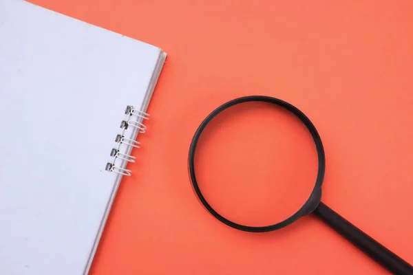Top View Magnifying Glass Notebook Isolate Orange Background Searching Concept — Fotografia de Stock