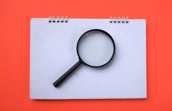 Magnifying Glass Notebook Isolate Orange Background Searching Concept — Fotografia de Stock