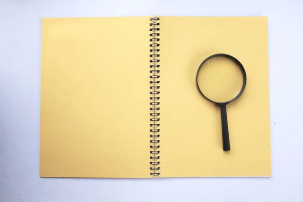 Memperbesar Kaca Dengan Notebook Isolasi Kuning Pada Latar Belakang Putih — Stok Foto