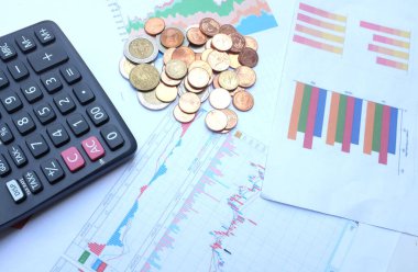 flat lay a glasses, money, calculator and chart or graph on office desk table.Finance and business concept. 