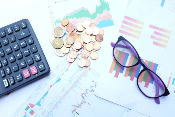 flat lay a glasses, money, calculator and chart or graph on office desk table.Finance and business concept.