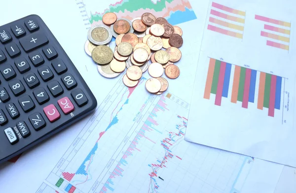 flat lay a glasses, money, calculator and chart or graph on office desk table.Finance and business concept. 