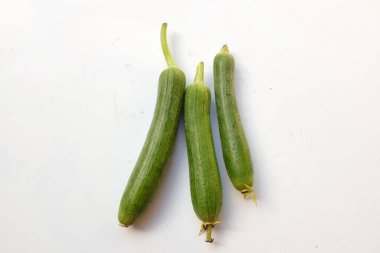 top view and close up fresh sponge gourd (luffa aegyptiaca) is family plant cucurbitaceae is vegetable herb and is short lived ivy isolated on white background.