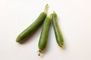 top view and close up three of fresh sponge gourd (luffa aegyptiaca) is family plant cucurbitaceae is vegetable herb and is short lived ivy isolated on white background.