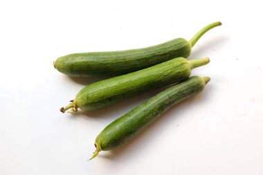 top view and close up three of fresh sponge gourd (luffa aegyptiaca) is family plant cucurbitaceae is vegetable herb and is short lived ivy isolated on white background.