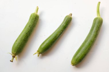 top view and close up three of fresh sponge gourd (luffa aegyptiaca) is family plant cucurbitaceae is vegetable herb and is short lived ivy isolated on white background.