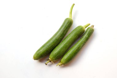 top view and close up fresh sponge gourd (luffa aegyptiaca) is family plant cucurbitaceae is vegetable herb and is short lived ivy isolated on white background.