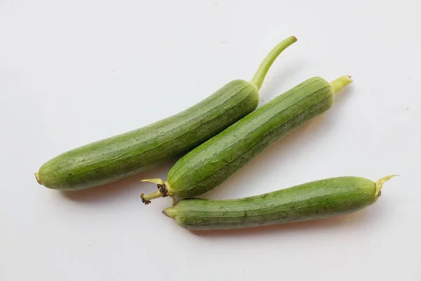 top view and close up fresh sponge gourd (luffa aegyptiaca) is family plant cucurbitaceae is vegetable herb and is short lived ivy isolated on white background.