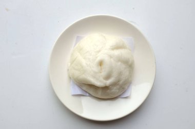 top view and flat lay  two stuffed delicious a steamed pork buns in white plate isolate on a white background