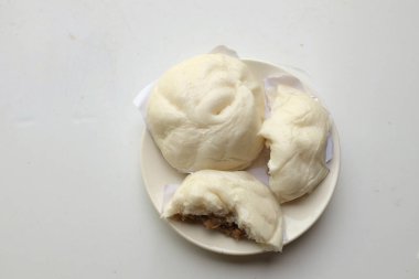 top view and flat lay  two stuffed delicious a steamed pork buns in white plate isolate on a white background