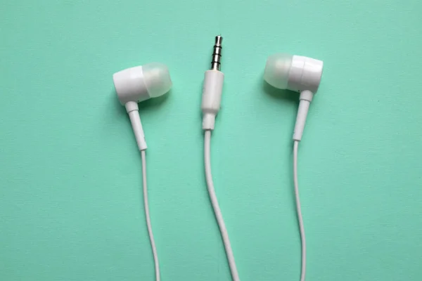White Headphones Earphone Earbuds Headset Isolated Green Pastel Background — Stock Photo, Image