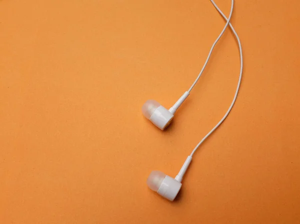 White Headphones Earphone Earbuds Headset Isolated Orange Background — Stock Photo, Image