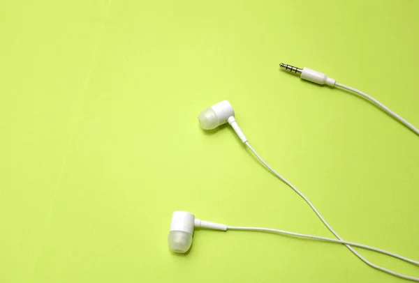 White Headphones Earphone Earbuds Headset Isolated Green Bright Background — Stock Photo, Image