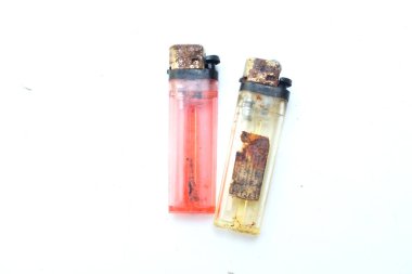 Paslı ve eski kırmızı, sarı plastik gaz kullan-at çakmak beyaz arka planda izole.
