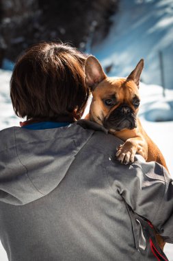 Sırtı beyaz, karlı arka planda, el ele tutuşmuş bir kadın.