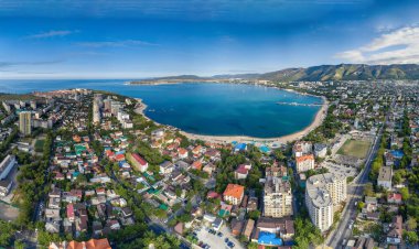 Panorama of Gelendzhik resort from a height, the Black Sea. The Gelendzhik Bay, the Caucasus Mountains are visible. Along the bay there are resort beaches, sanatoriums and boarding houses