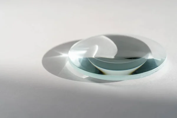 Transparent crystal lens on a white background. — Stock Photo, Image