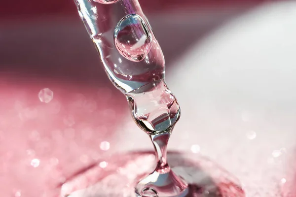 Cosmetic pipette with a pink on dark background. — Stock Photo, Image