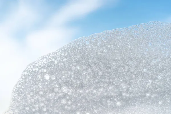 Texture of white foam on a sky background. — Stock Photo, Image