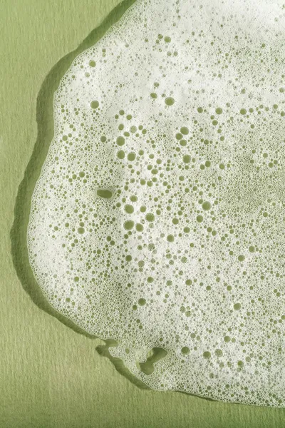 Texture of white foam on a green background. — Stock Photo, Image