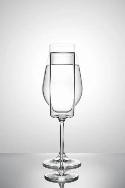 Two glasses of different shapes on a white background. — Stock Photo, Image