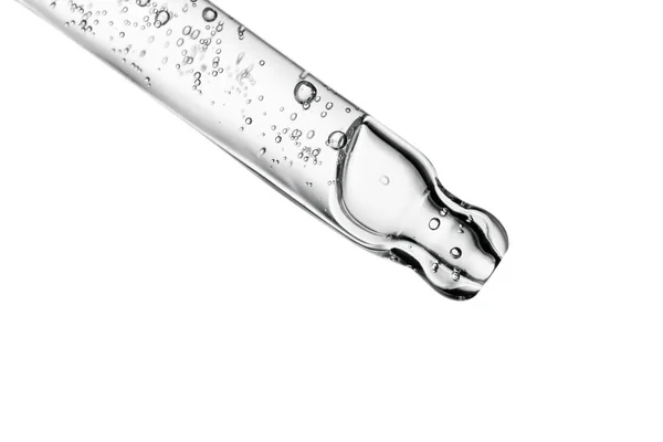 Beyaz izole bir zemin üzerinde kozmetik ürünleri olan şeffaf pipet.