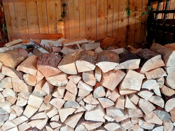 Roofed chopped wood for the winter, heating, supplies