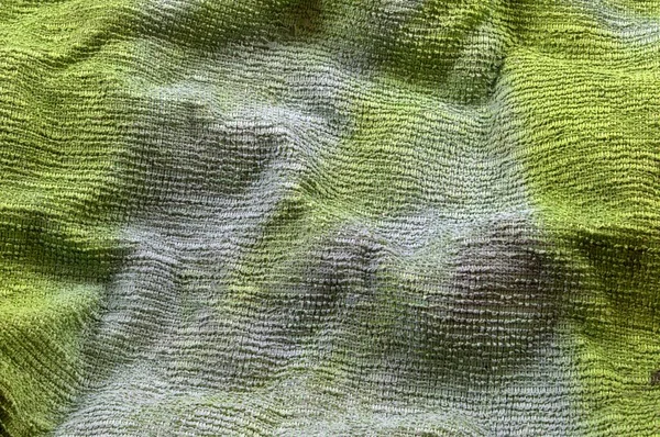 Abstraction. Green background of crumpled fabric. Different shades of green