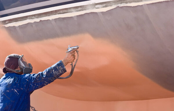 spray painter during the  painting of a ship's hull