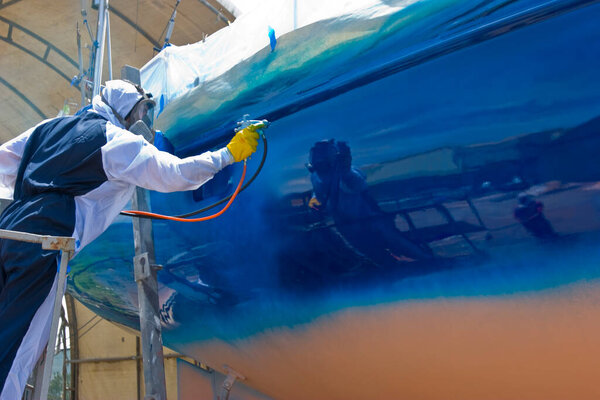spray painter during the  painting of a ship's hull