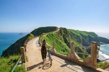 woman with bicycle on Sark Island, Guernsey, Channel Islands, UK, Great britain