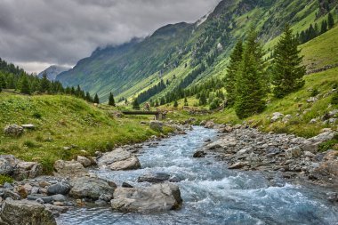 nice active senior woman riding her electric mountain bike in the Jamtal Valley, silvretta mountain range near Gaschurn, Tyrol, Austria