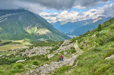 nice active senior woman riding her electric mountain bike in the silvretta mountain range near Gaschurn, Tyrol, Austria