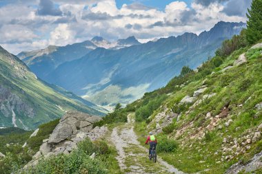 nice active senior woman riding her electric mountain bike in the silvretta mountain range near Gaschurn, Tyrol, Austria
