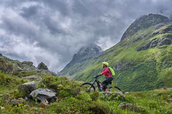 nice active senior woman riding her electric mountain bike in the Jamtal Valley, silvretta mountain range near Gaschurn, Tyrol, Austria