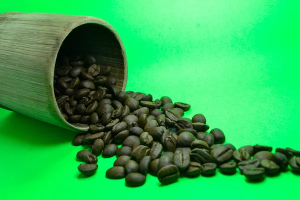 Кофейные Зерна Разливаются Бамбукового Стекла Зеленом Фоне — стоковое фото