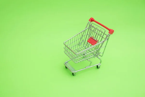 Empty Shooping Trolley Cart Green Background — Stock Photo, Image