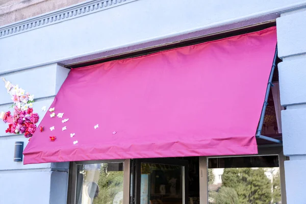 Clean pink awning with flowers for logo, text presentation mockup
