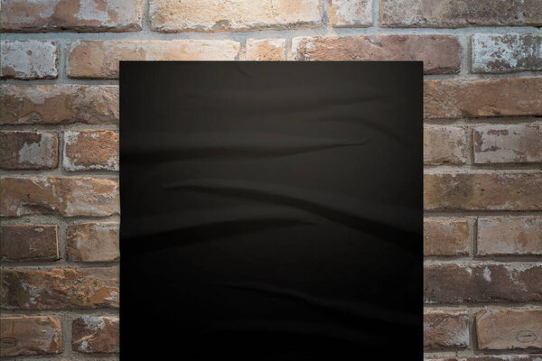 Black clean poster on brick wall with lamp light over