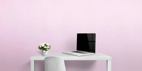 Small work desk with laptop and flowers. Blank laptop screen for web page presentation. Copy space on pink wall