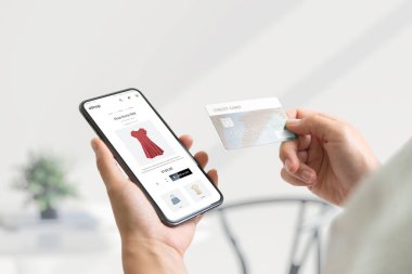 Shopping online with smart phone and credit card concept. Modern e-commerce web page with with women's clothing