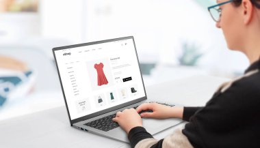 Woman shopping online with laptop. Concept of buying women's clothing online on e-commerce websites 