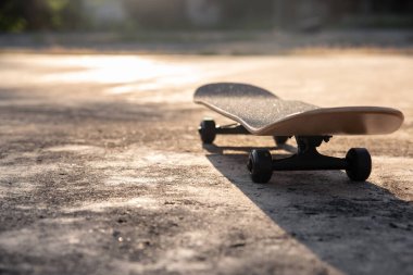 Skateboard putting on cement ground, extreme sport and outdoor activity.