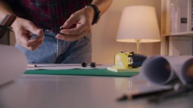 Hands of Engineer using vernier caliper to scale the black screw, Engineering and industrial concept.