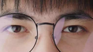 Close-up to eyes of Asian teenager wearing eye glasses
