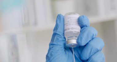 COVID-19 aşı şişesini tutan bilim adamı ya da doktorun eli, insanlara enjekte edilmeye hazır olun..