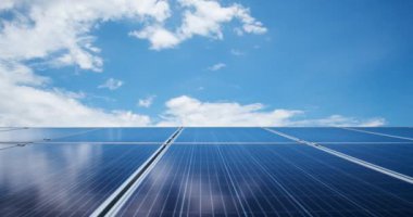 Solar cells panel on rooftop with blue and cloudy sky, Green energy and world sustainable concept.