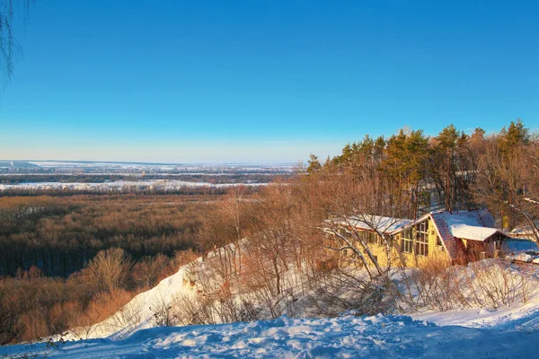 Winter landscape on the mountain with a cabin