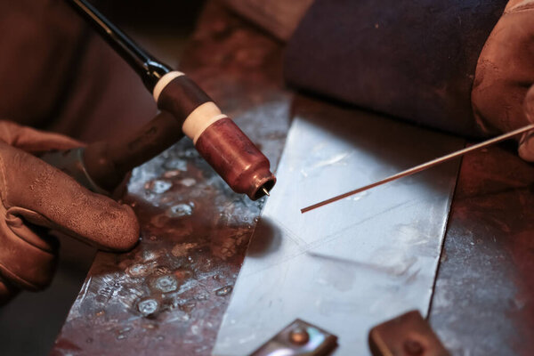 Argon arc welding torch in the welder's hand