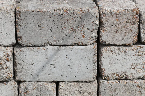 Tahta paletler üzerinde inşaat için beton bloklar açık hava deposunda, yakın planda. Satılık beton yapı malzemeleri..